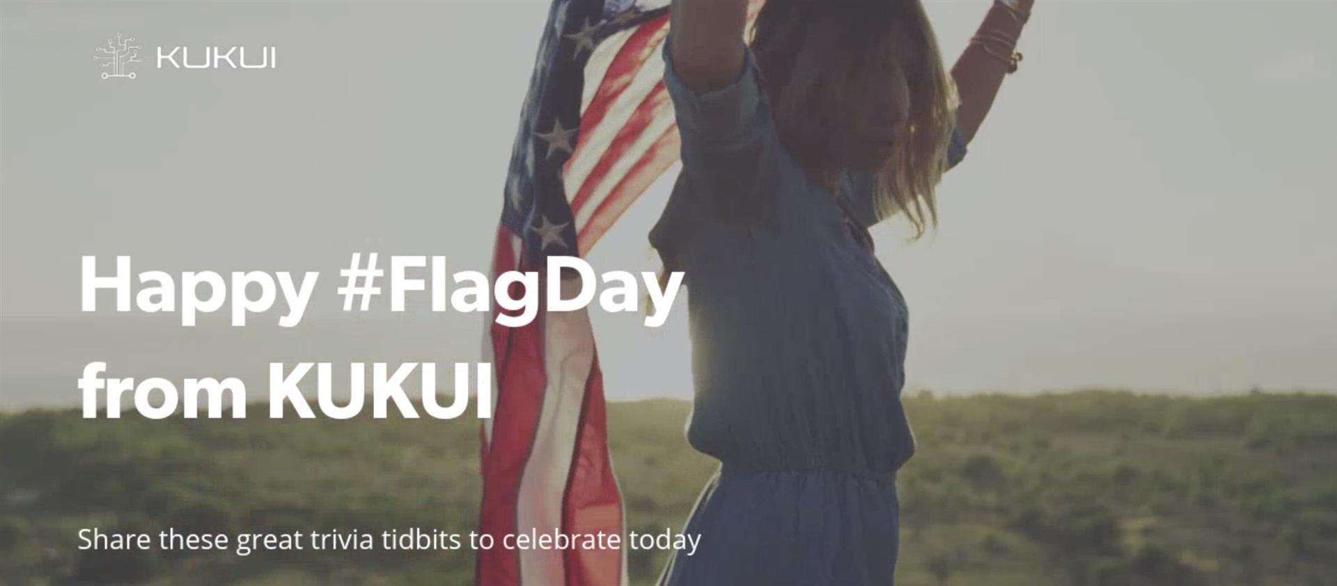 A woman is holding an american flag in a field.