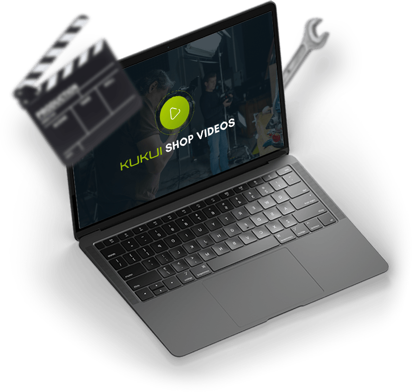 A laptop with a clapper board and a wrench on it