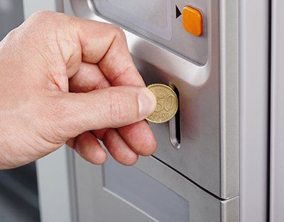 Inserting Coin - Vending Machine Merchandise in Silver Spring, MD