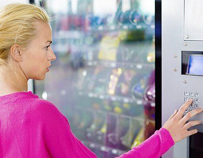 Woman Pressing Vending Machine - Vending Machine Merchandise in Silver Spring, MD