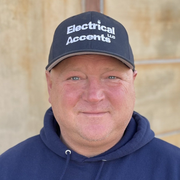 A man wearing a hat that says electrical accents on it