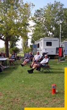 older people sitting in a caravan park