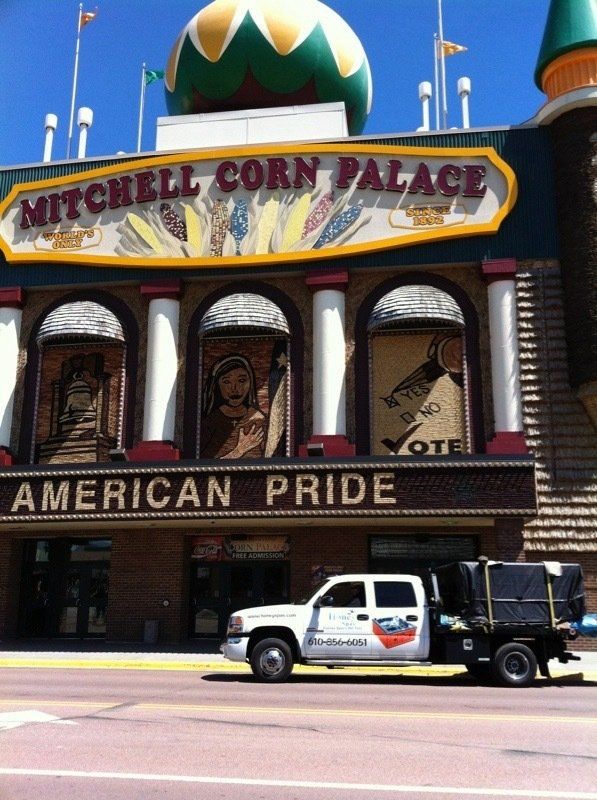 Mitchell Corn Palace exterior with a white truck in front; brown, tan, and green building.