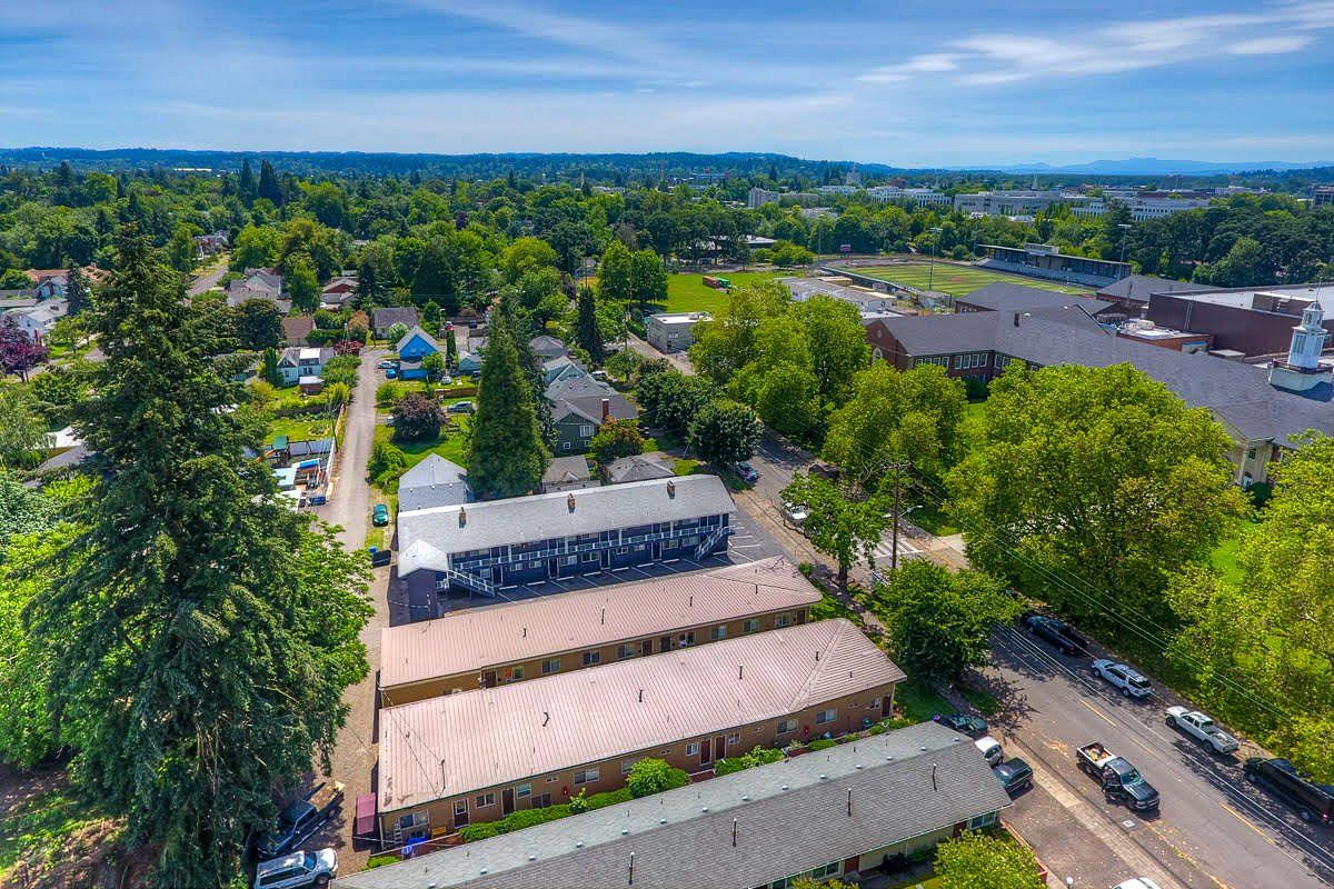 An aerial view of a residential area with lots of trees and buildings.