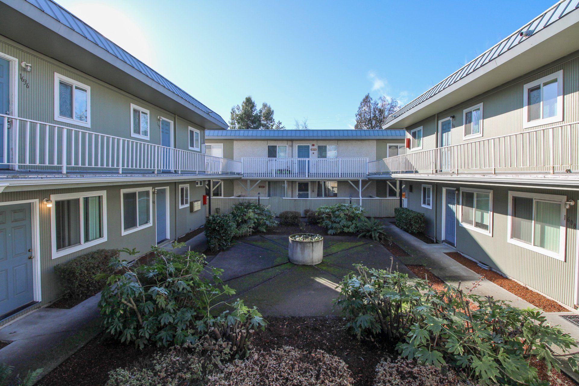 A row of apartment buildings with a courtyard in the middle