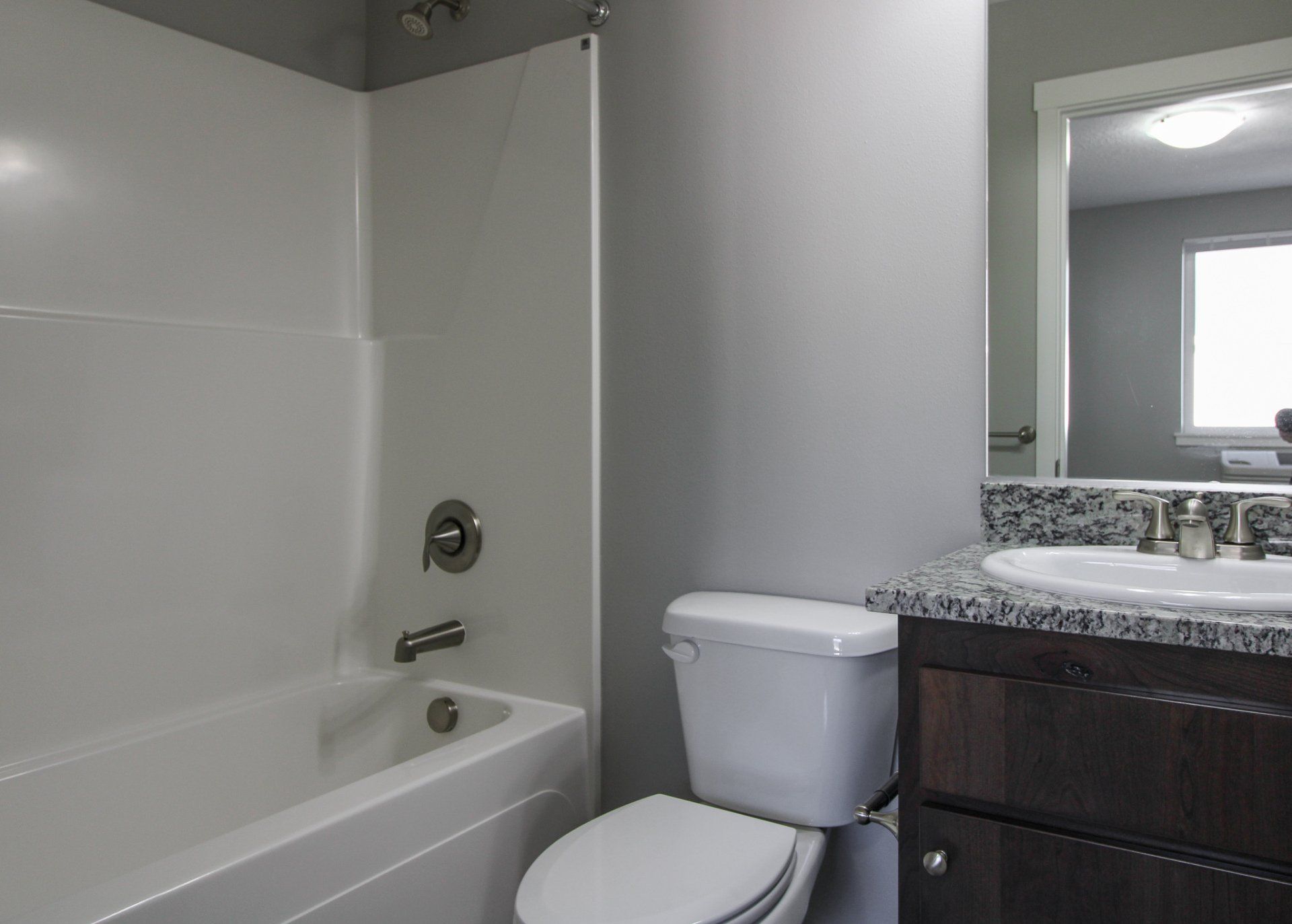 A bathroom with a toilet , sink and bathtub