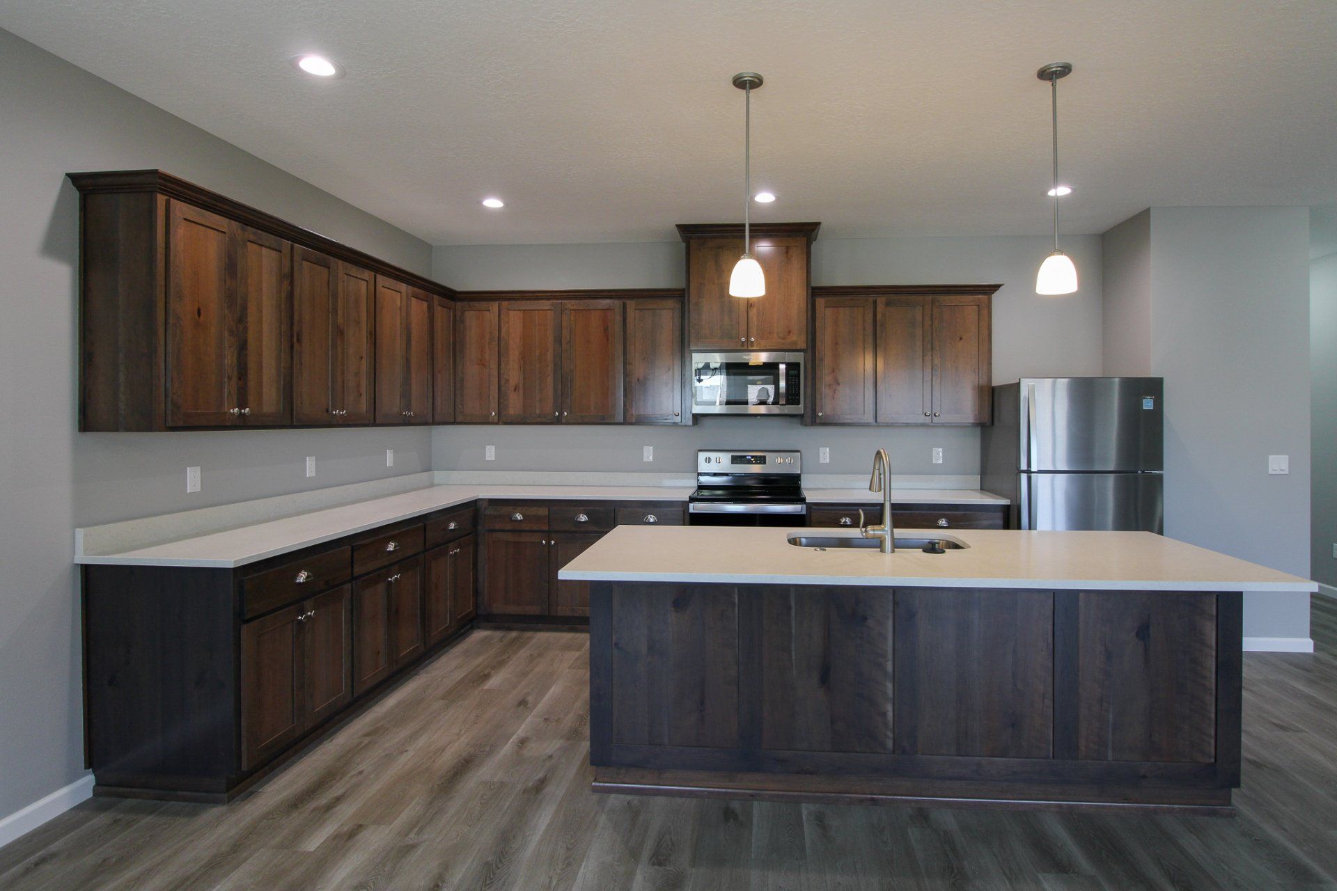 A kitchen with a large island and stainless steel appliances