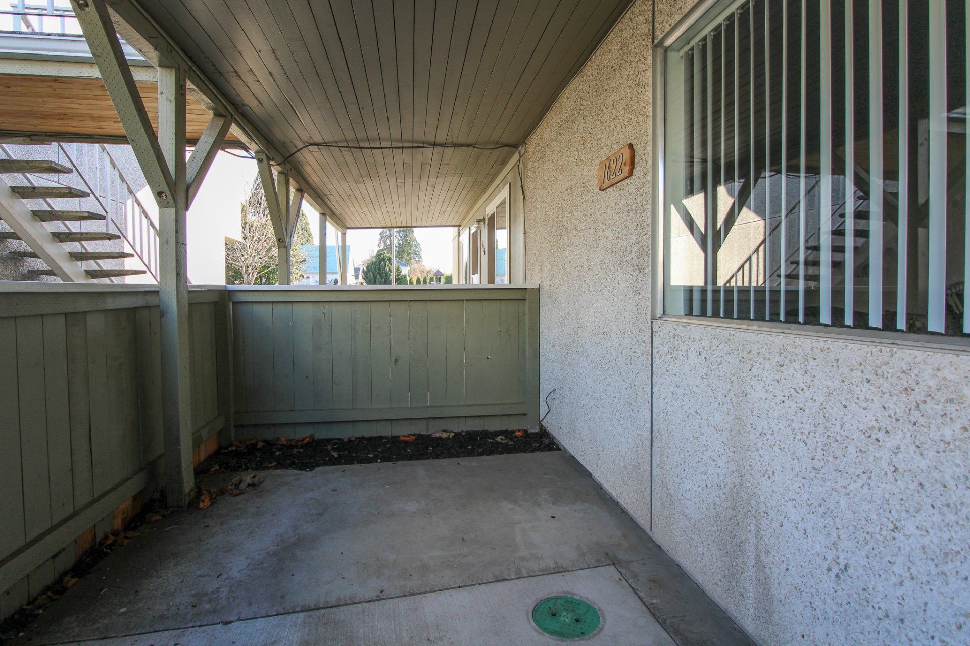 A building with a covered porch and a window