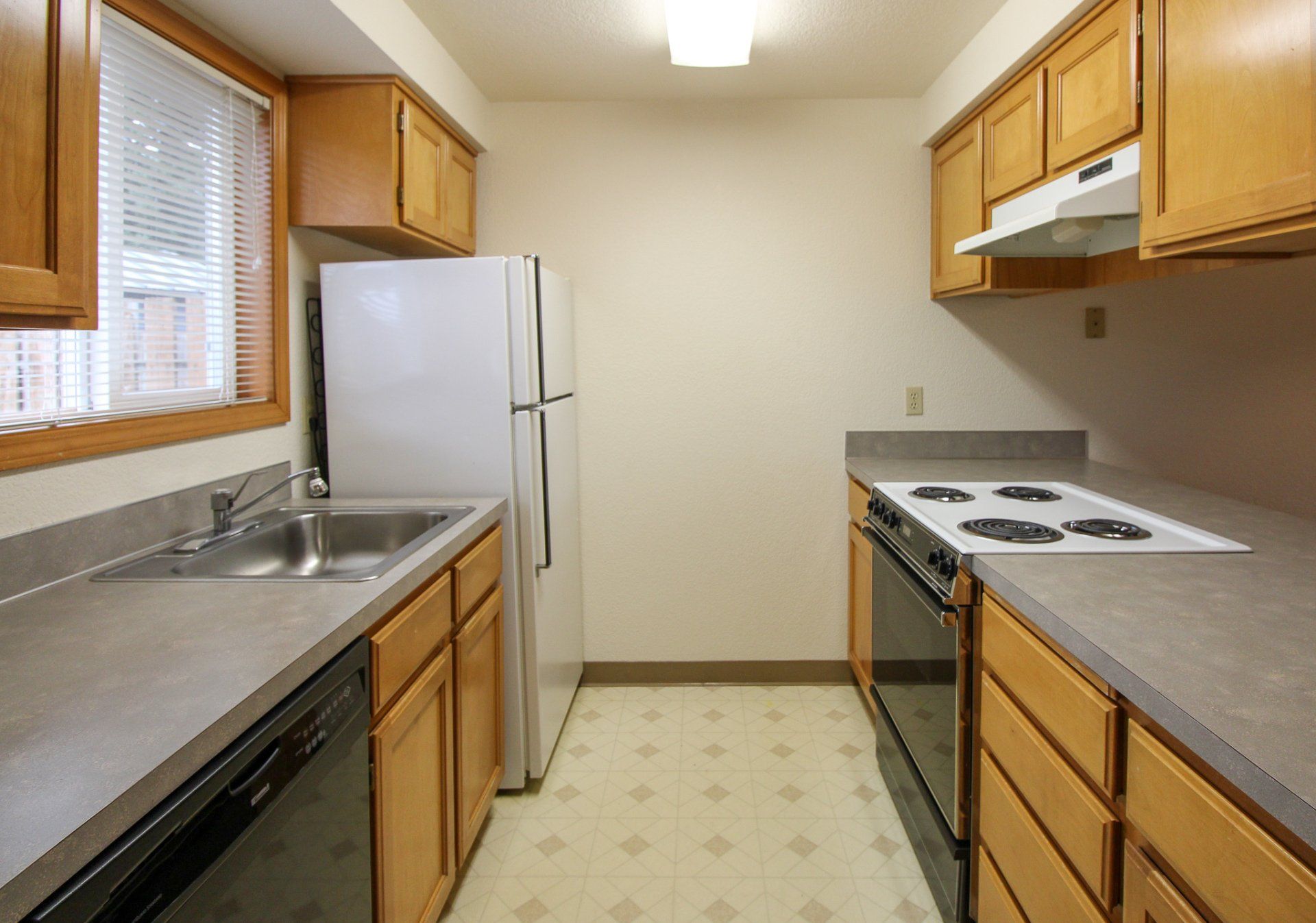 A kitchen with a refrigerator stove sink and dishwasher