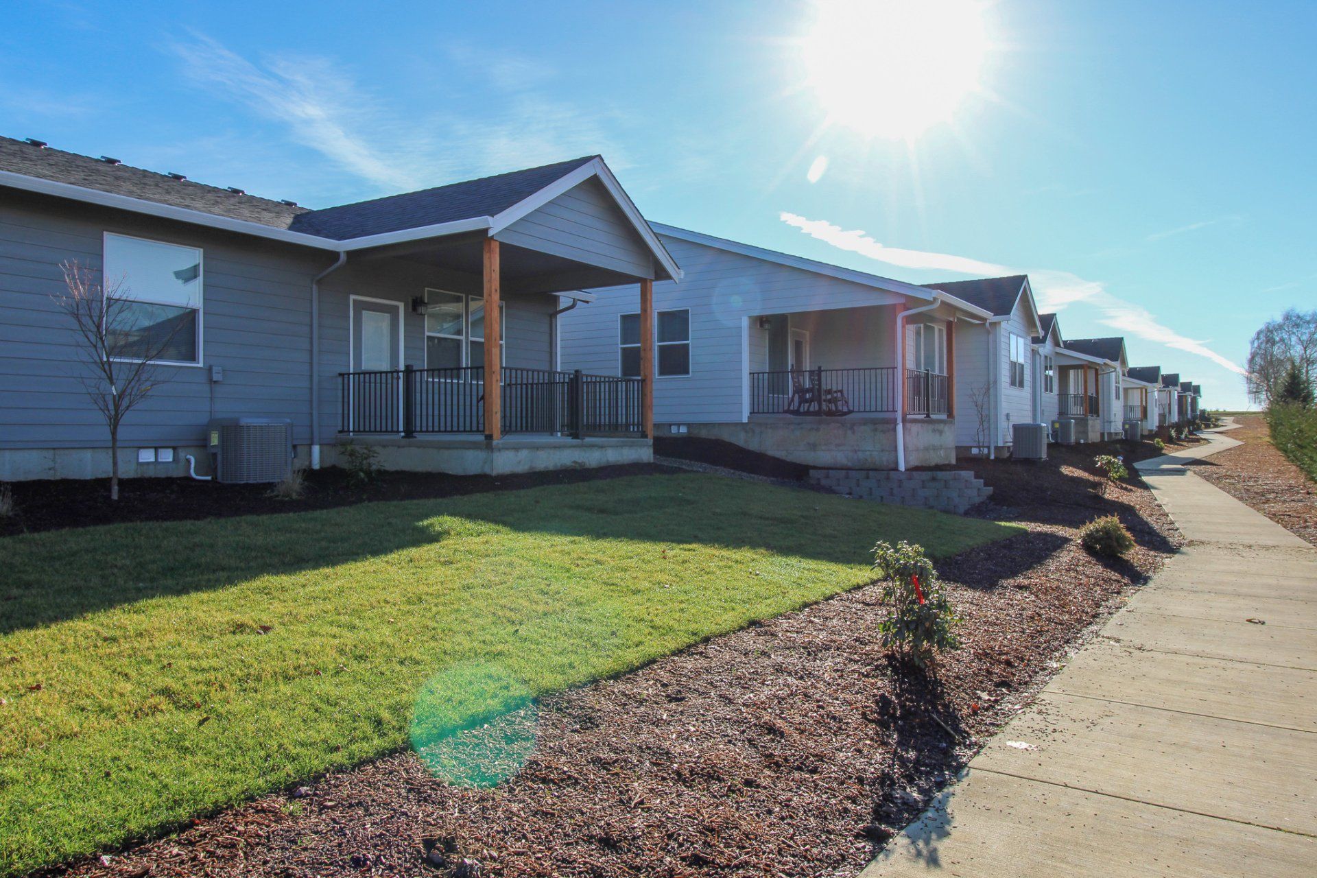 A row of mobile homes are lined up next to each other on a sunny day.
