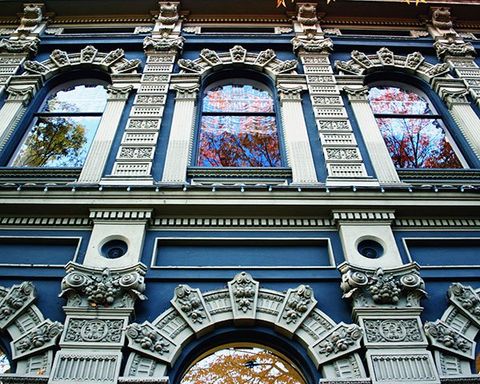 The exterior of an ornate blue building.
