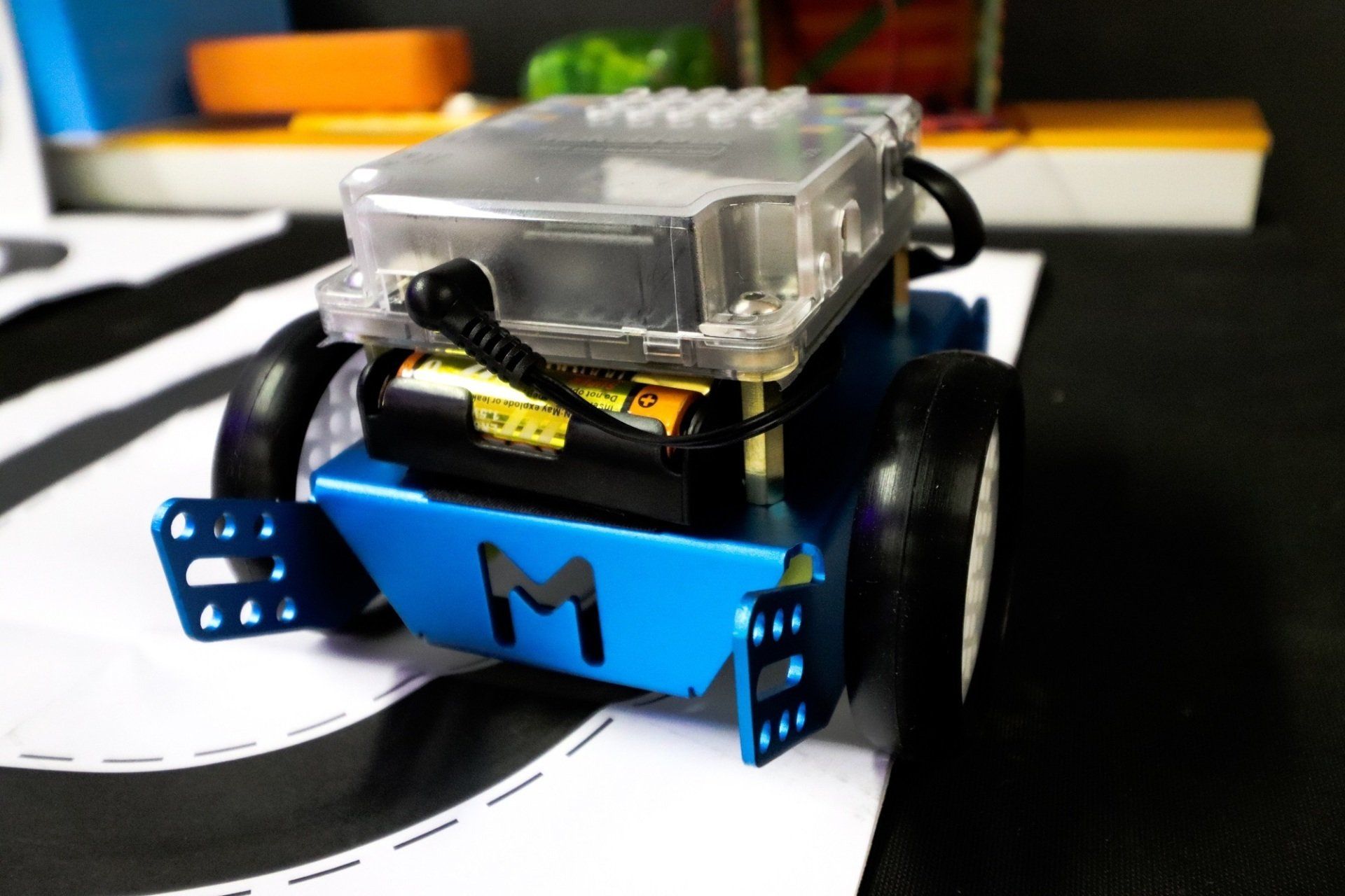 a blue robot with the letter m on it