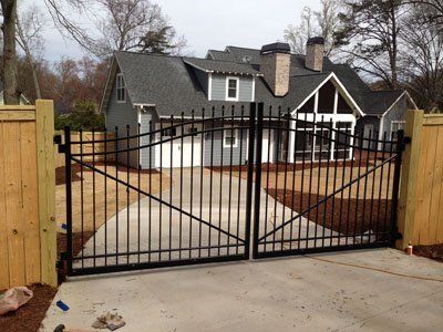 Installed Aluminum Fence on a Wooden Fence — Greenville, SC — Pioneer Fence in Greenville