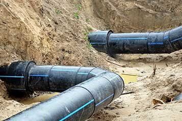 Two Black Plastic Bent Pipes — Residential Septic Services in Naples and Collier County, FL Two Black Plastic Bent Pipes — Residential Septic Services in Naples and Collier County, FL
