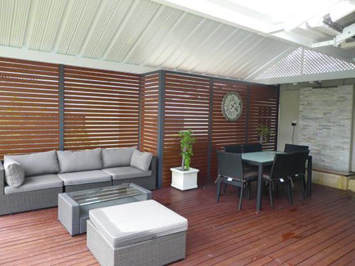 A Living Room With a Wooden Deck — Attention to Detail Cleaning Services & Deck Coating Darwin in Casuarina, NT