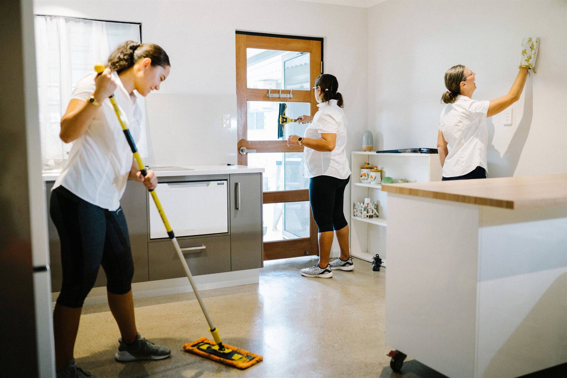 Three Cleaners Cleaning An Apartment — Attention to Detail Cleaning Services & Deck Coating Darwin in Casuarina, NT