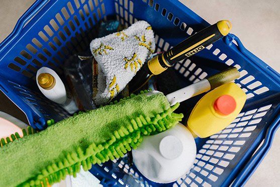 A blue basket filled with cleaning supplies — Attention to Detail Cleaning Services & Deck Coating Darwin in Casuarina, NT
