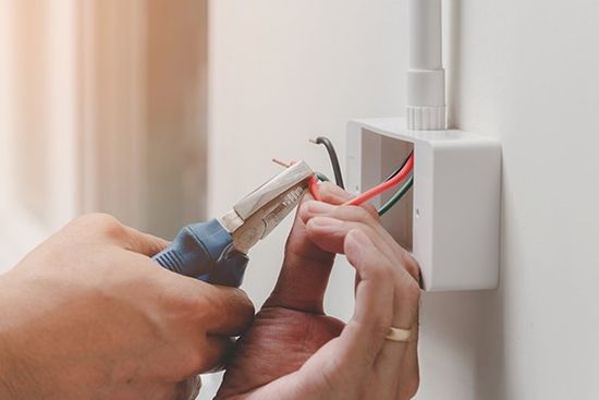 Technician Is Using a Pliers Wrench — Cape Coral, FL — Always Affordable Electric Technician Is Using a Pliers Wrench — Cape Coral, FL — Always Affordable Electric