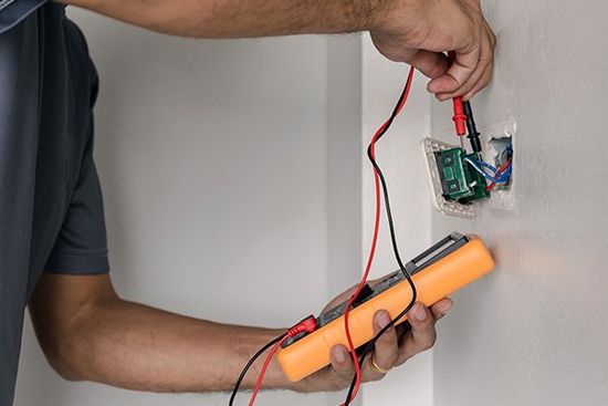 Electrician Is Using a Digital Meter — Cape Coral, FL — Always Affordable Electric Electrician Is Using a Digital Meter — Cape Coral, FL — Always Affordable Electric