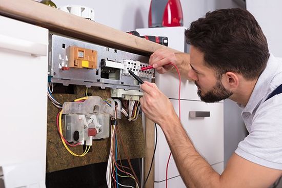 Male Technician Examining Dishwasher — Cape Coral, FL — Always Affordable Electric Male Technician Examining Dishwasher — Cape Coral, FL — Always Affordable Electric