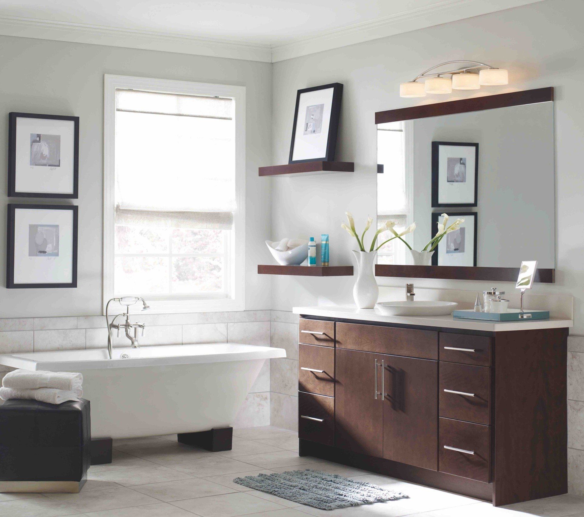 A bathroom with a tub a sink and a mirror