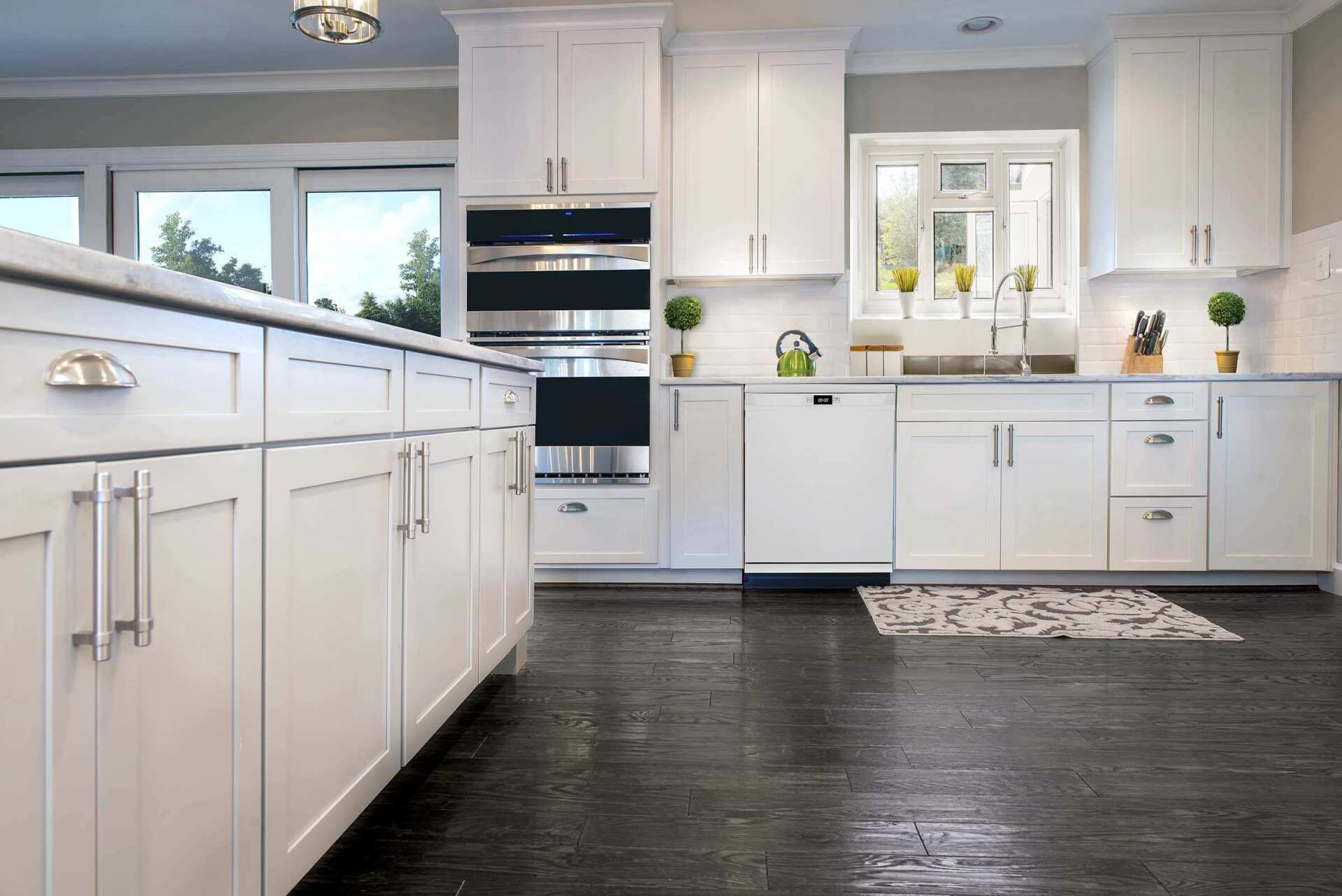 A kitchen with white cabinets and stainless steel appliances.