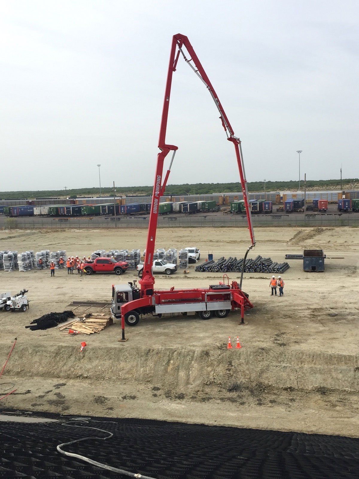 Concrete Truck With Crane Arm Extended High Up