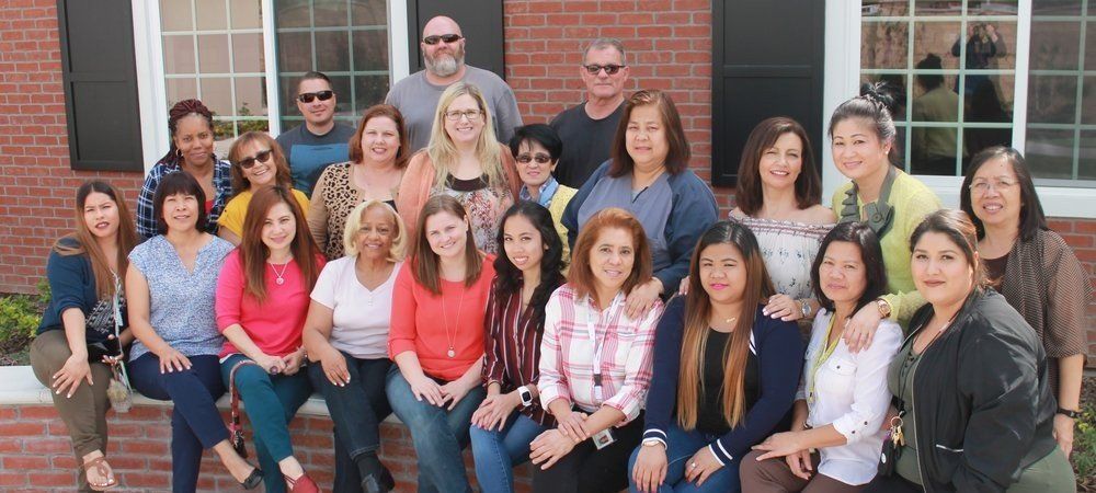 Staff photo wearing casual clothes containing approximately 20 people. Staff photo contain approximately 20 people.