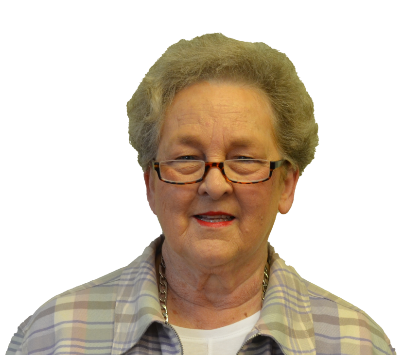 Woman with glasses and short, curly gray hair smiles, wearing a plaid shirt and gold chain.