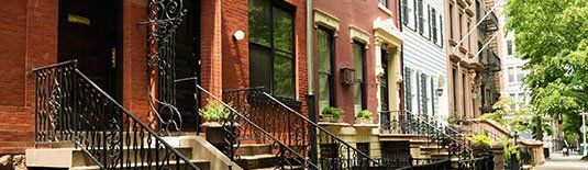 A row of NY apartments viewed from the street.
