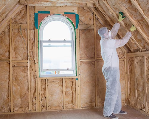 Man Working in Protective Suit - Green Fiber Insulation in Ogden, UT