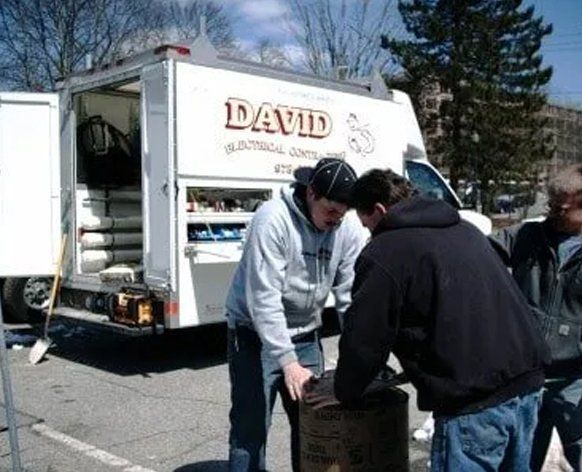 Electrician with David Electrical Truck — North Andover, MA — David Electrical Contracting LLC Electrician with David Electrical Truck — North Andover, MA — David Electrical Contracting LLC