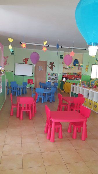 sala con tavolini in un asilo nido