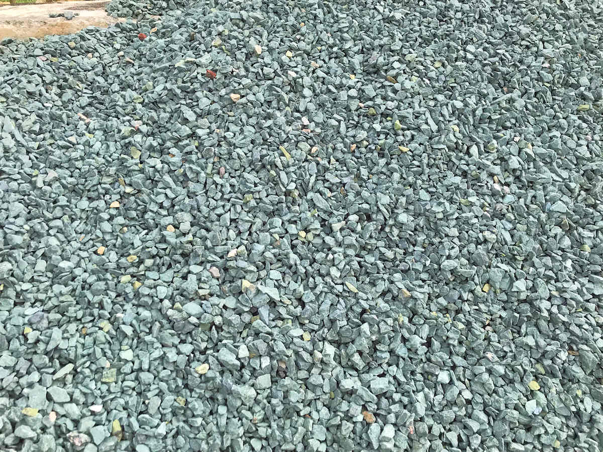 Pile of blue-gray gravel, possibly for landscaping or construction, outdoors.