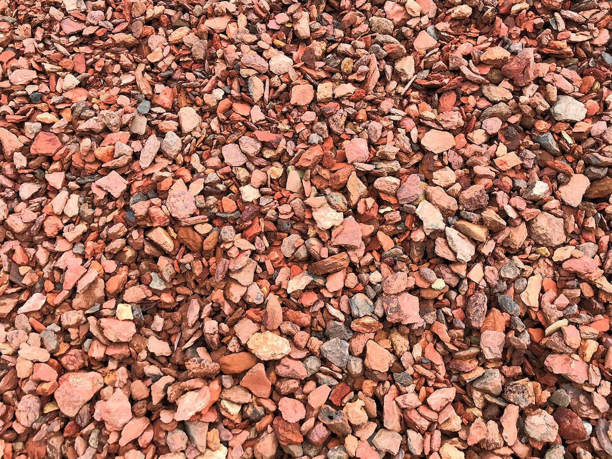Crushed red brick pieces, covering the ground.