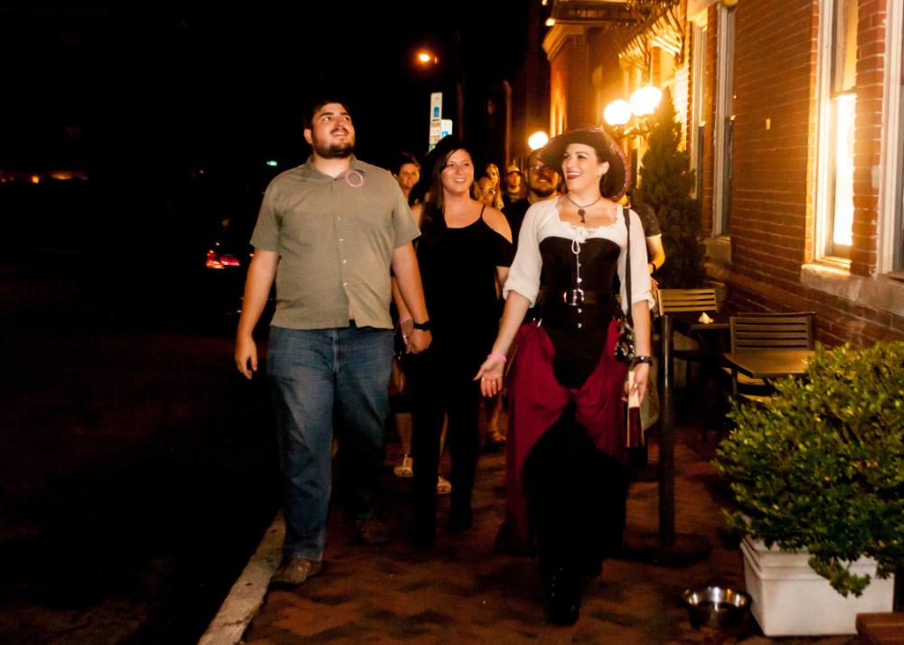 night tour of group with festively dressed tour guide