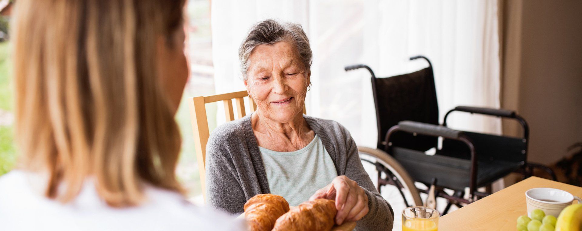 Image of a resident selecting a fresh croissant from a platter