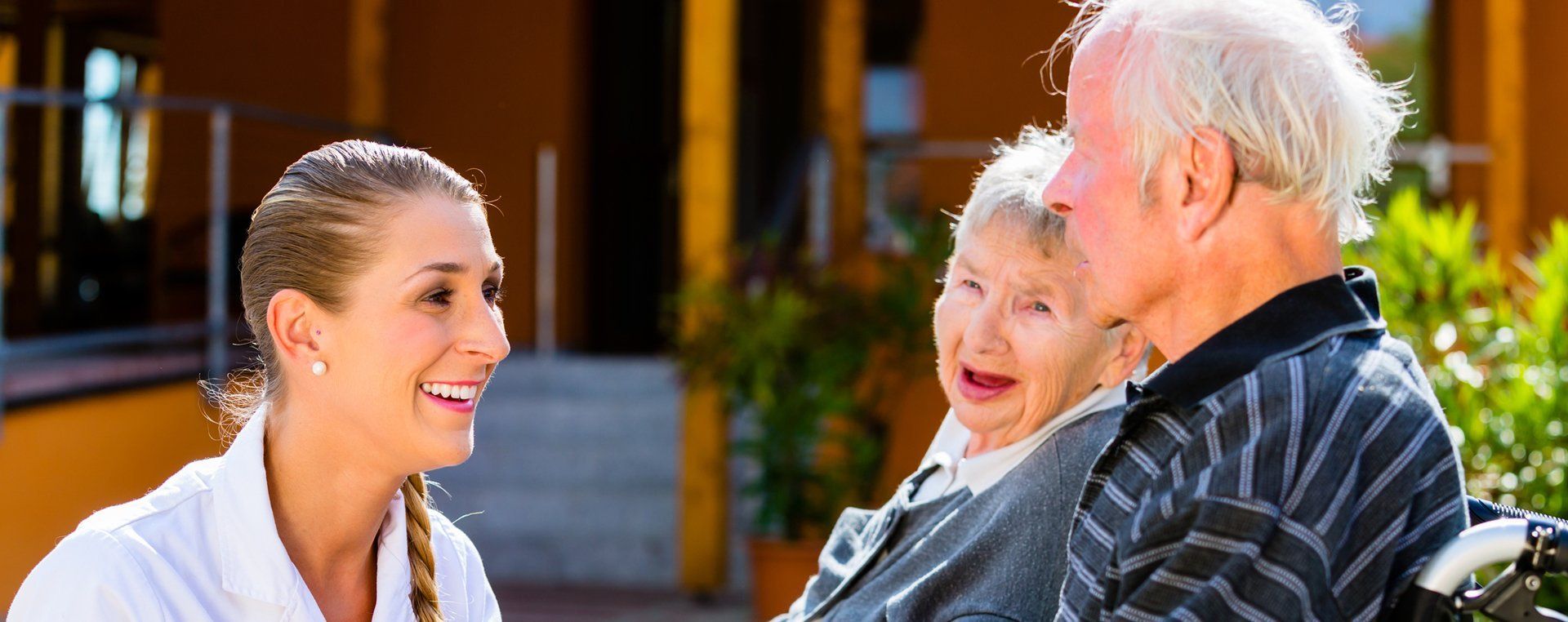 Memory Care Residents Enjoying Conversation With Caregiver