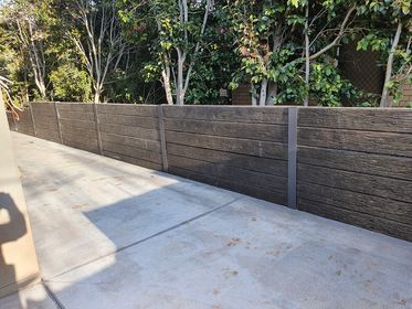 concrete slab with timber retaining wall