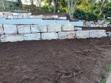 sandstone retaining wall on red soil