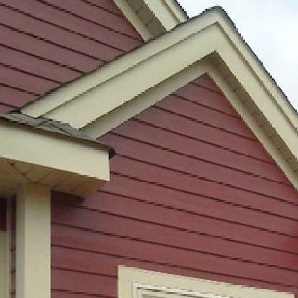 A red house with white trim and a white roof