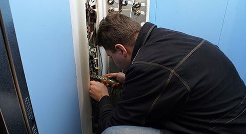 Mechanic Repairing Elevator Button — elevator installation in Bothell, WA Mechanic Repairing Elevator Button — elevator installation in Bothell, WA