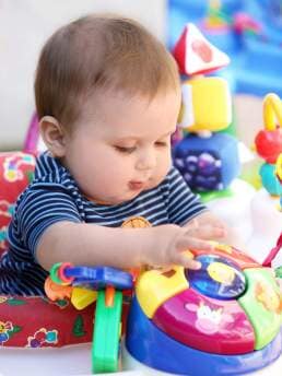 Infant child playing with toys - Cottage School , Boulder, Colorado Infant child playing with toys - Cottage School , Boulder, Colorado