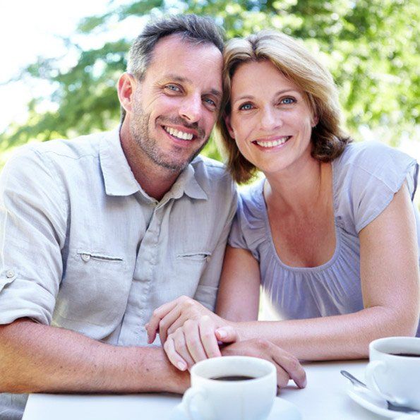 image of couple smiling and drinking coffee
