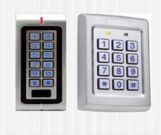 Two white keypad access control devices; one with red light, one with green.