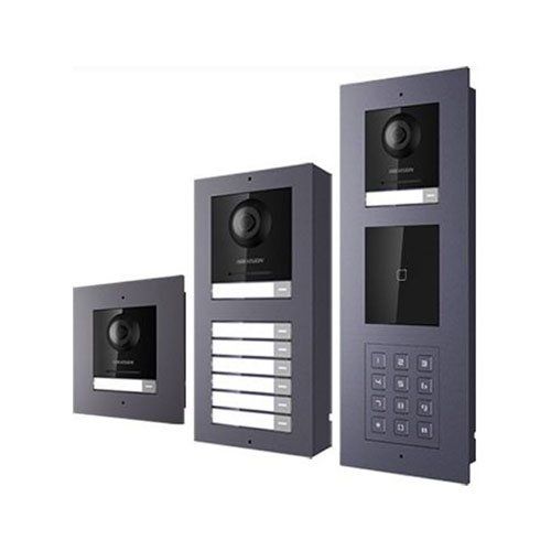 Three dark gray intercom units with cameras, nameplates, and keypads.