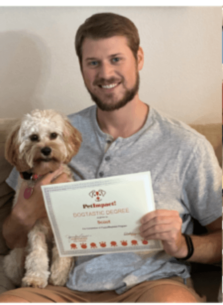 Man smiling with a dog, holding a certificate that says