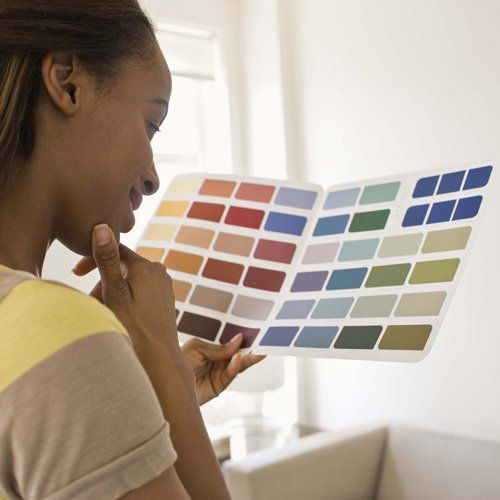 Woman looking at colour catalogue woman looking at colour catalogue