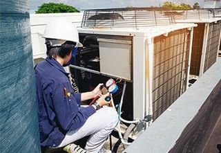 Technician Repairing Air Conditioning — Air Conditioning Contractors in Forest City NC Technician Repairing Air Conditioning — Air Conditioning Contractors in Forest City NC