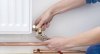 Technician Repairing Heater — Heating & Air Conditioning Contractors in Forest City NC Technician Repairing Heater — Heating & Air Conditioning Contractors in Forest City NC
